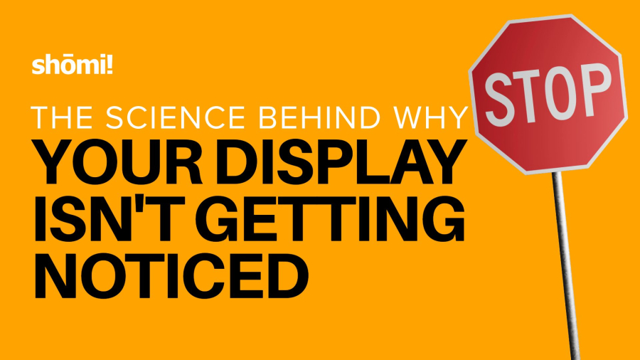 An orange background with a red stop sign on the right. The text reads: shomi! Discover the science behind why your display isn't getting noticed.