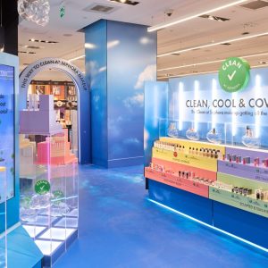 Interior view of a Sephora store featuring blue displays labeled Clean, Cool & Coveted with shelves showcasing makeup products organized by category.