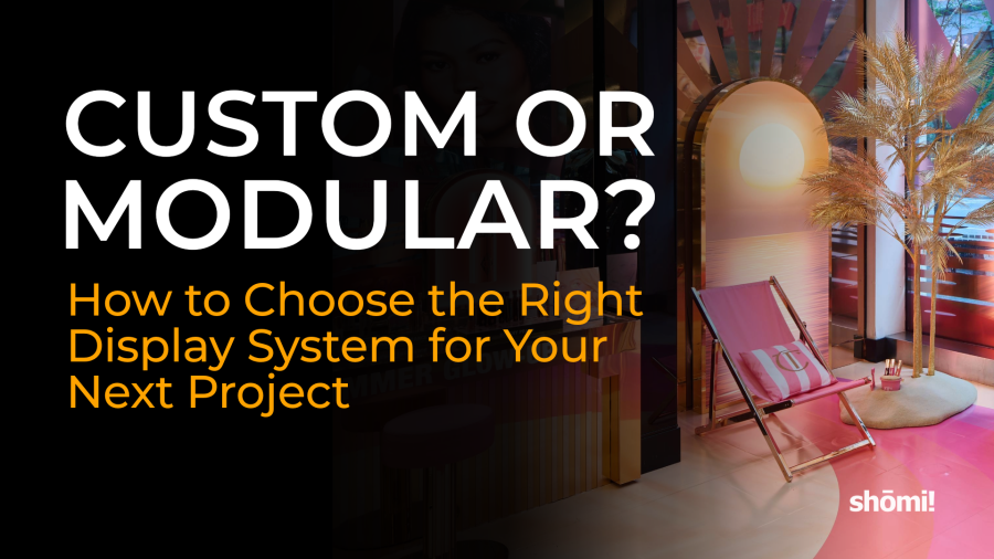 The Shōmi logo sits in the corner of a retail display featuring a pink beach chair, an arch, and a palm tree, accompanied by the text: CUSTOM OR MODULAR? How to Choose the Right Display System for Your Next Project.